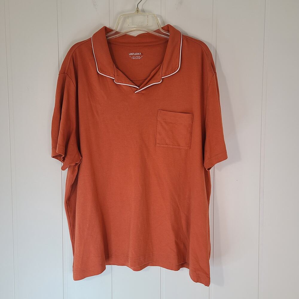 UNTUCKit Altavia Johnny Collar men's polo shirt in orange with white piping.